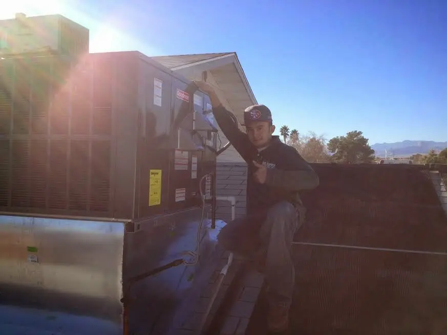 HVAC technician performing Air Duct Repair on a rooftop unit in Murphy